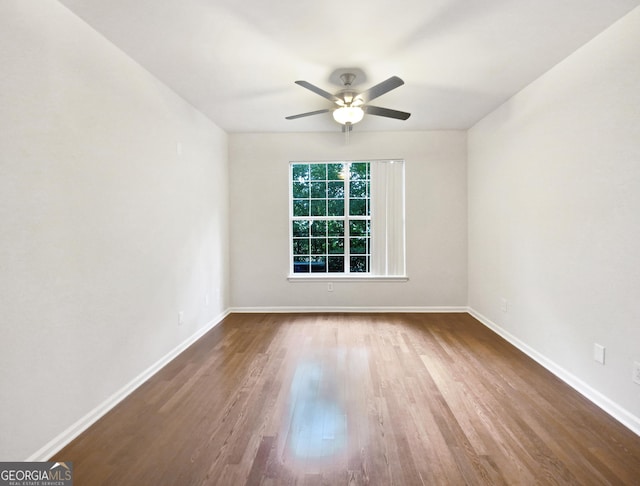 unfurnished room featuring ceiling fan, baseboards, and wood finished floors