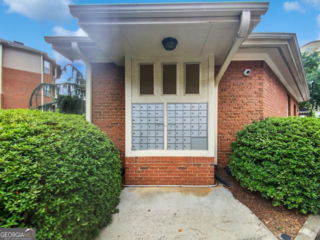 entrance to property featuring brick siding