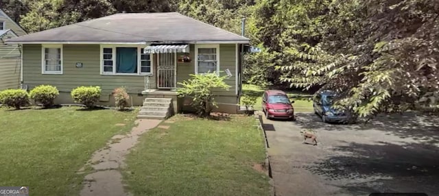 bungalow-style house with a front lawn