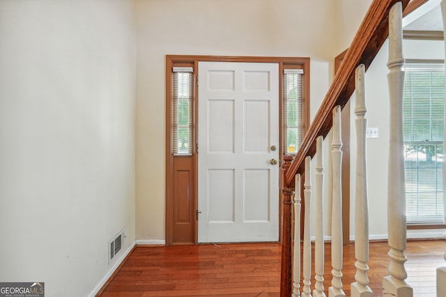 entryway with hardwood / wood-style floors and plenty of natural light