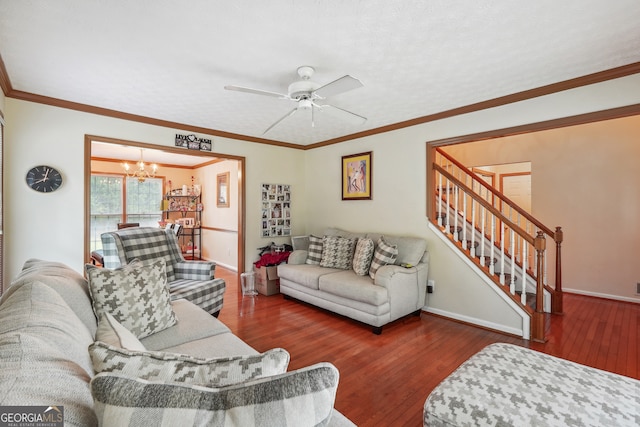 living room with ceiling fan with notable chandelier, crown molding, and hardwood / wood-style floors