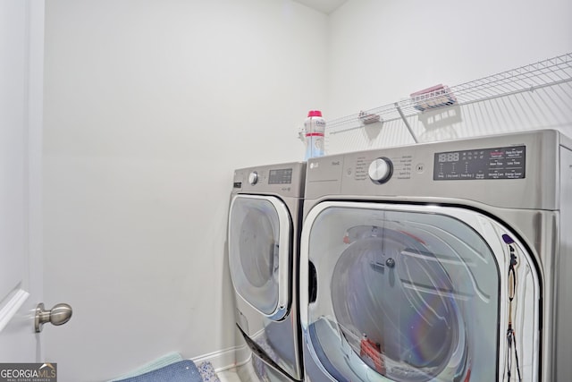 washroom featuring washer and clothes dryer