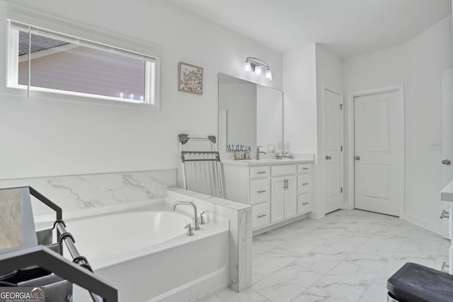 bathroom featuring vanity and a tub