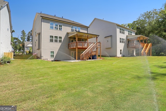 back of house with a lawn and a deck