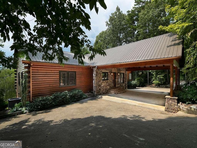 exterior space featuring a carport and central air condition unit