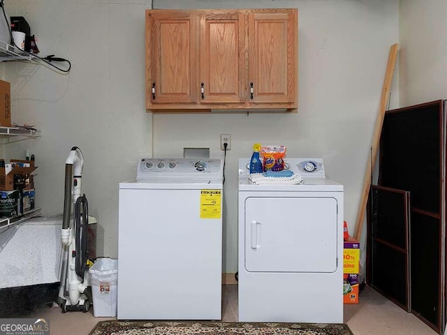 laundry room with cabinets and washer and clothes dryer