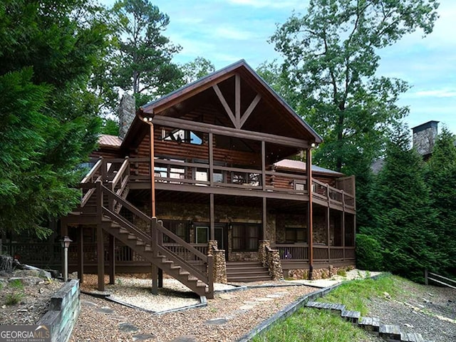 back of property featuring a wooden deck