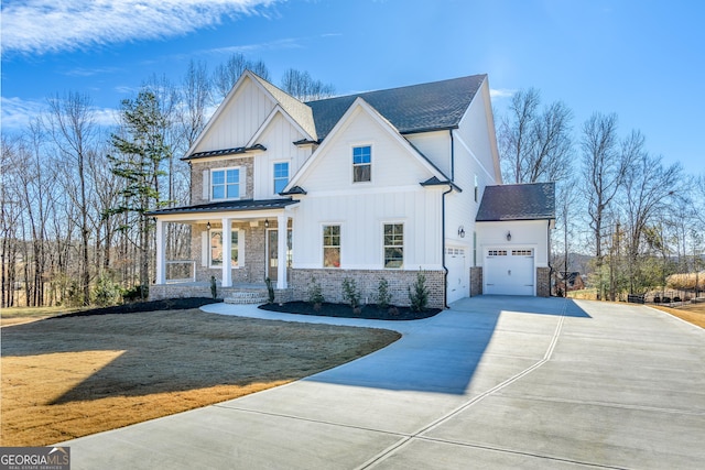 view of front of house featuring a garage, covered porch, and a front lawn