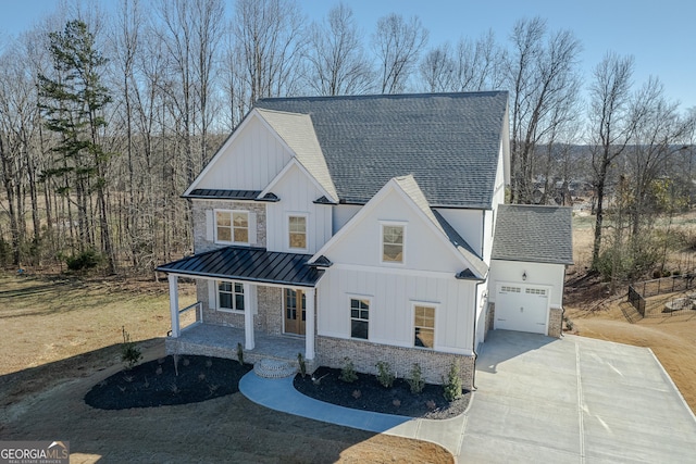 modern farmhouse featuring a garage and a porch