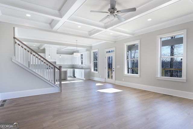 interior space with beamed ceiling, ceiling fan, coffered ceiling, and hardwood / wood-style flooring