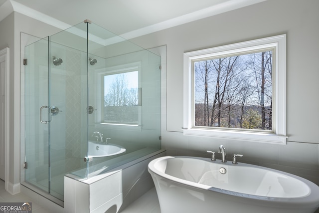 bathroom featuring tile patterned floors, plenty of natural light, and separate shower and tub