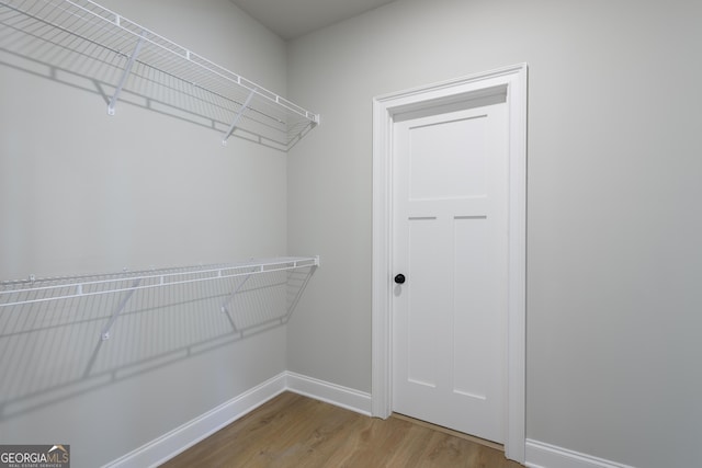 spacious closet featuring hardwood / wood-style floors