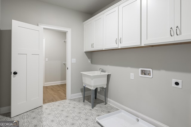 laundry room with cabinets, hookup for an electric dryer, and hookup for a washing machine