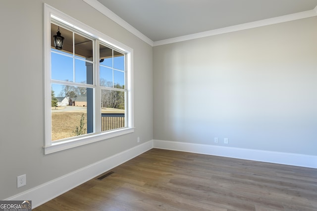 unfurnished room with wood-type flooring and crown molding