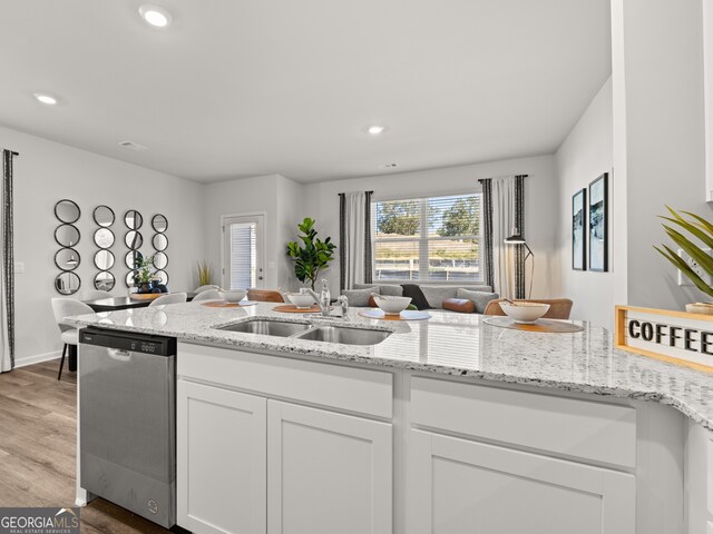 kitchen with light stone countertops, sink, dishwasher, hardwood / wood-style floors, and white cabinets