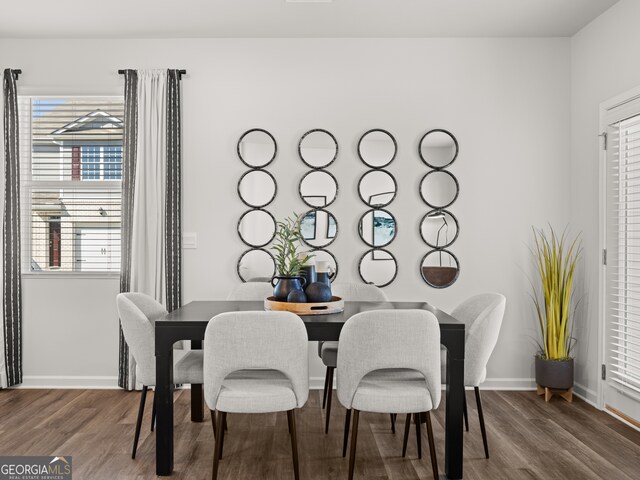 dining area with dark hardwood / wood-style flooring