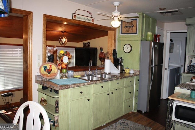 kitchen with stainless steel fridge, wood-type flooring, green cabinets, sink, and ceiling fan