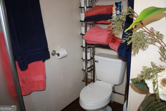 bathroom featuring toilet and hardwood / wood-style flooring