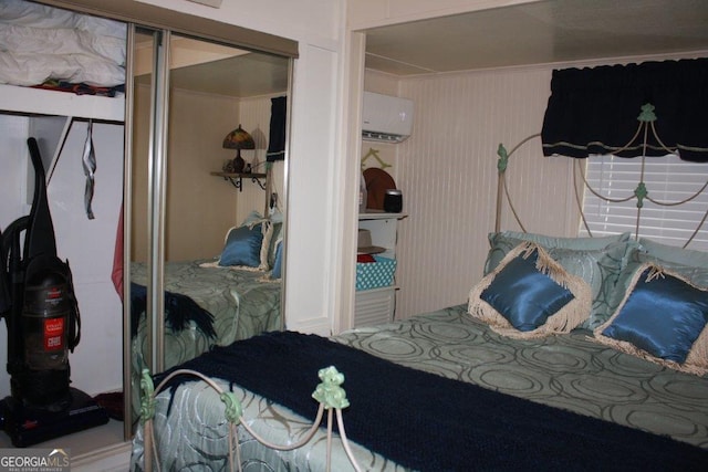 bedroom featuring a closet and a wall unit AC