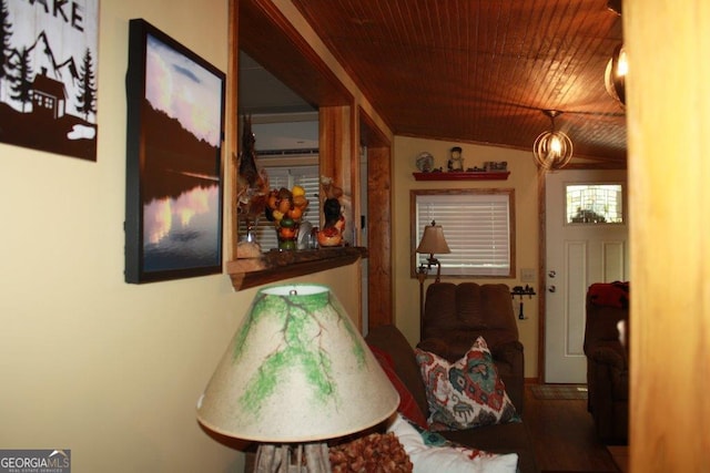 hallway with wood-type flooring and vaulted ceiling