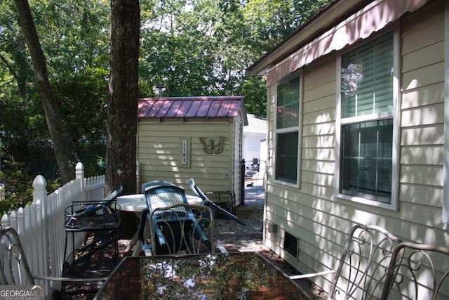 view of side of home with a storage shed