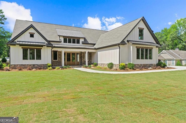 modern farmhouse featuring a front yard and a porch