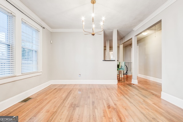 unfurnished dining area featuring light hardwood / wood-style flooring, ornamental molding, and a notable chandelier