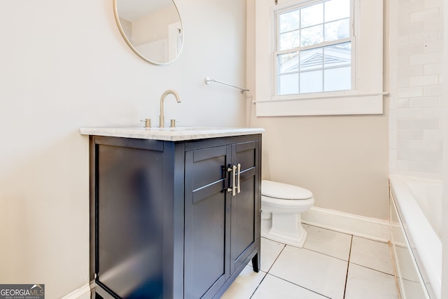 bathroom featuring toilet, a tub, tile patterned floors, and vanity