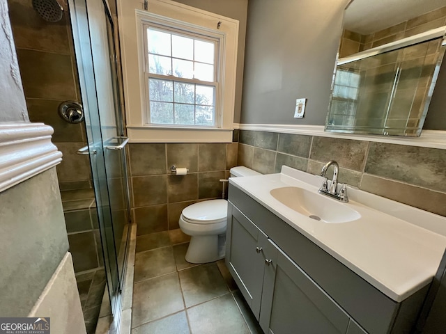 bathroom featuring an enclosed shower, vanity, toilet, and tile patterned flooring