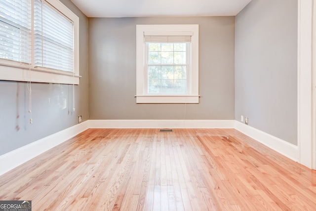 spare room featuring light wood-type flooring