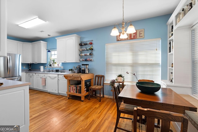 kitchen with white cabinets, dishwasher, freestanding refrigerator, and open shelves