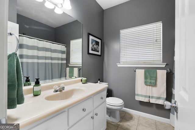 bathroom featuring toilet, a shower with shower curtain, tile patterned flooring, baseboards, and vanity