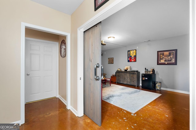 foyer entrance with baseboards and finished concrete floors