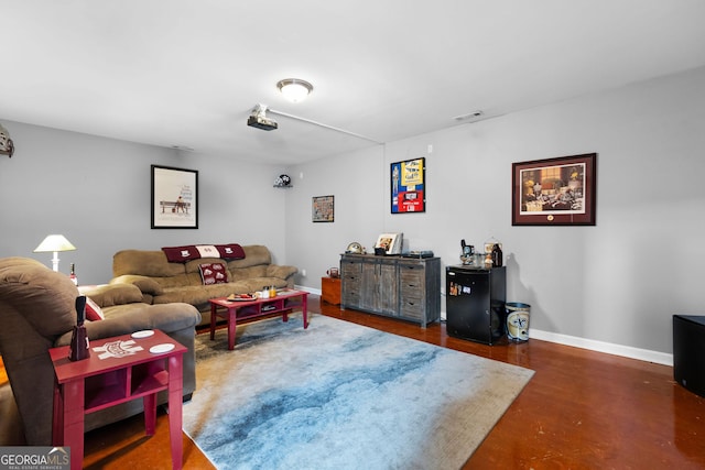 living area featuring baseboards and visible vents