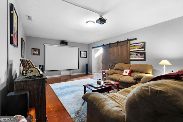 home theater featuring visible vents, baseboards, and a barn door