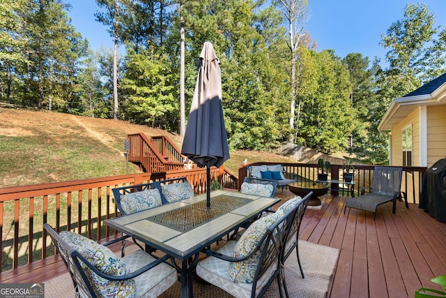 wooden deck featuring an outdoor living space, outdoor dining area, and a yard