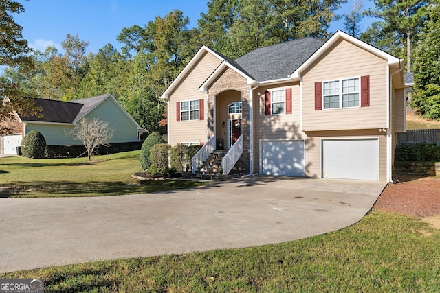 split foyer home with a front yard, a garage, and driveway