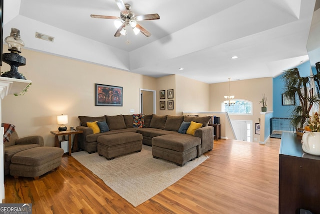 living room with recessed lighting, ceiling fan with notable chandelier, visible vents, and light wood-type flooring