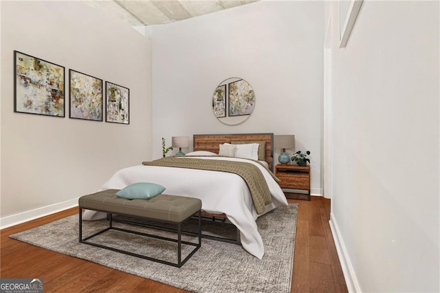 bedroom with dark wood-type flooring