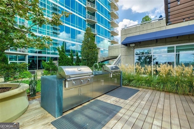 wooden deck featuring a grill and exterior kitchen