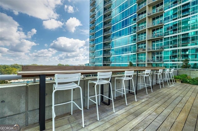 wooden deck featuring exterior bar