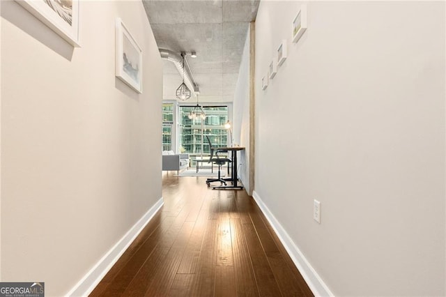 hall with hardwood / wood-style flooring and an inviting chandelier