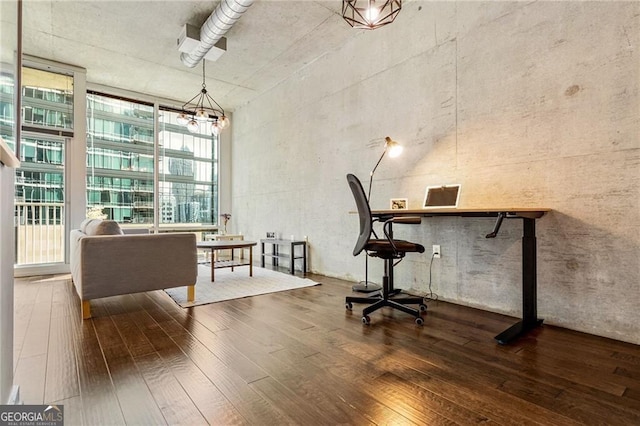 office area with dark hardwood / wood-style flooring and an inviting chandelier