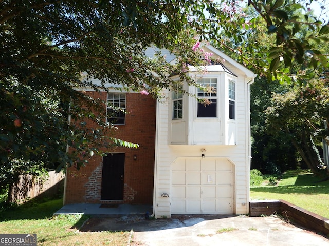 view of outbuilding featuring an attached garage and fence