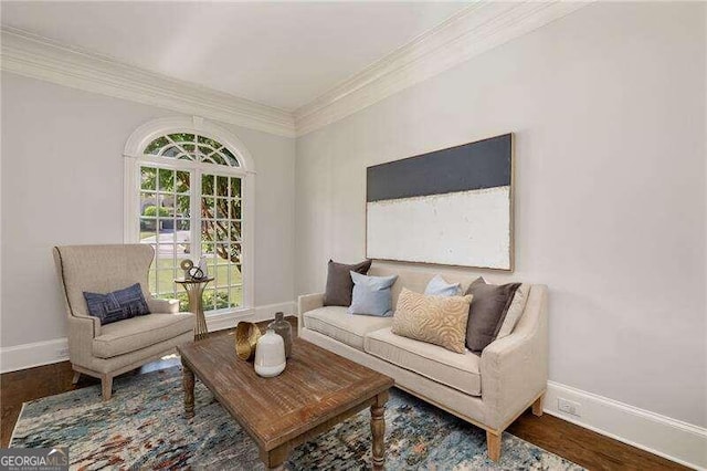 living area featuring hardwood / wood-style flooring and ornamental molding