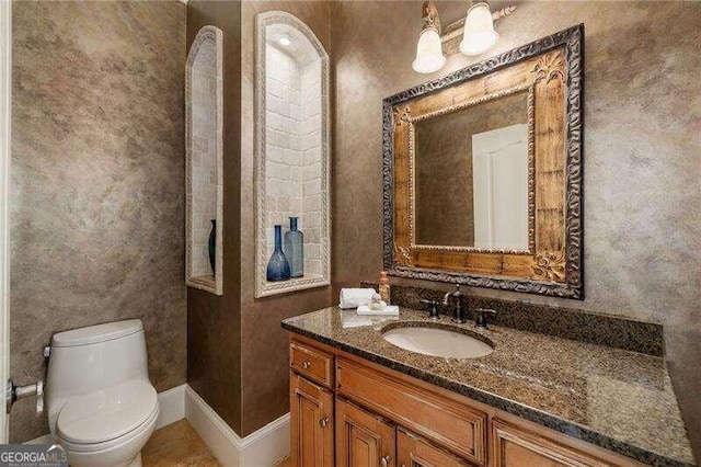 bathroom featuring vanity and toilet