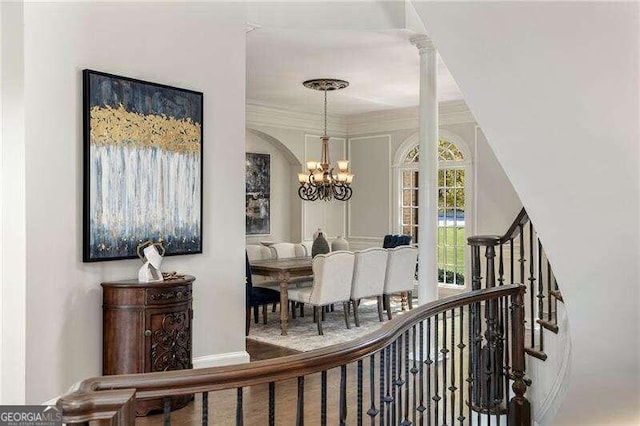 interior space featuring crown molding and a notable chandelier