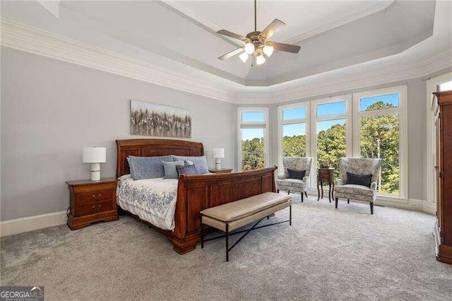 bedroom featuring a tray ceiling, crown molding, and ceiling fan