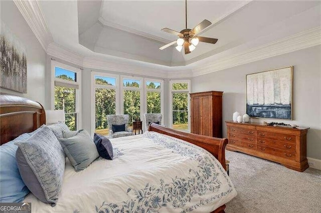 bedroom featuring light carpet, ceiling fan, a raised ceiling, and crown molding