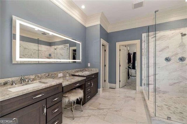 bathroom featuring a tile shower, crown molding, and vanity